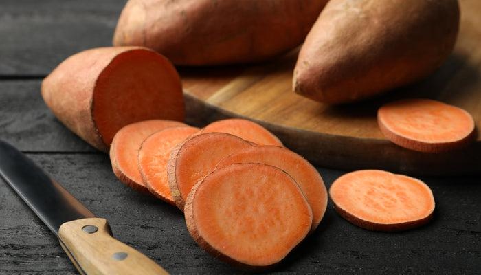 Isolated raw sweet potatoes 