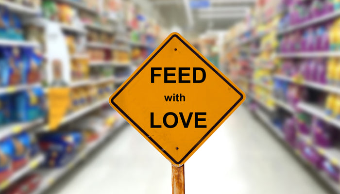 "Feed With Love" sign in middle of dog food aisle